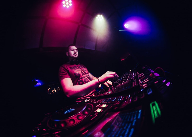 enjoyment, musical instrument, dj, human, stage, techno, nightclub, musician, real people, occupation, party - social event, playing, colour, lighting equipment