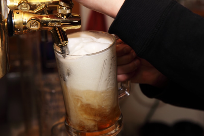 person, service, food and drink, yellow, taps, alcohol, lager, household equipment, pint, beer, pint glass, brew, bubbles, foam, bar, pub, froth, indoors