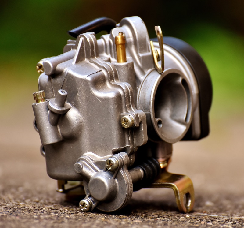 metal, human representation, carburetor, machine part, no people, industry, focus on foreground, transportation, motor, steel, selective focus, motorcycle carburetor