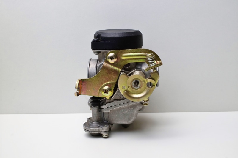 technology, machinery, petrol, air, petrol air mixture, still life, gray background, retro styled, scooter carburetor, motorcycle carburetor, old-fashioned