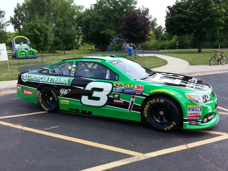 racer, motor vehicle, outdoors, road, government, stock car, communication, mode of transportation, transportation, green color, 3, austin dillon, street