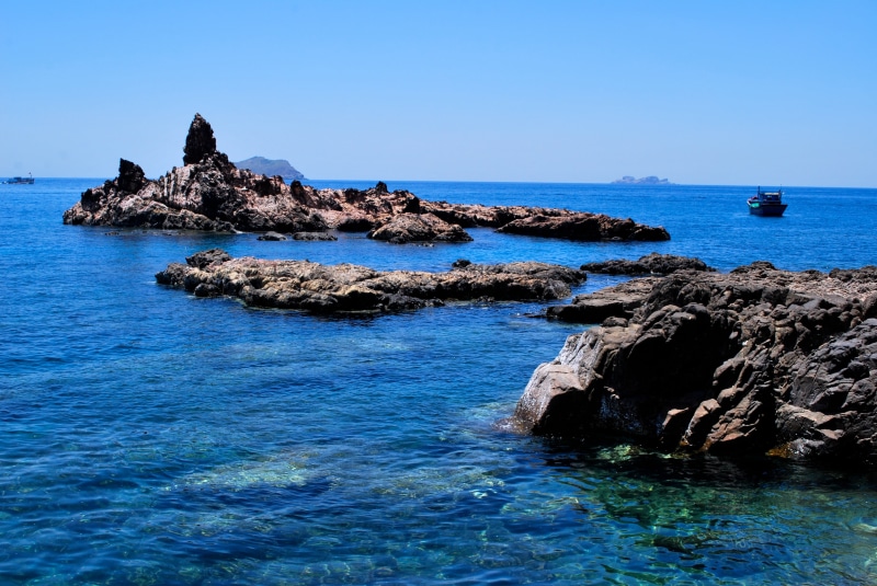 sky, rock, day, natural, rock - object, blue sea, solid, scenic flask, sea, clear sky, tranquil scene, no people, tranquility, blue, land, mercy of the wind waist