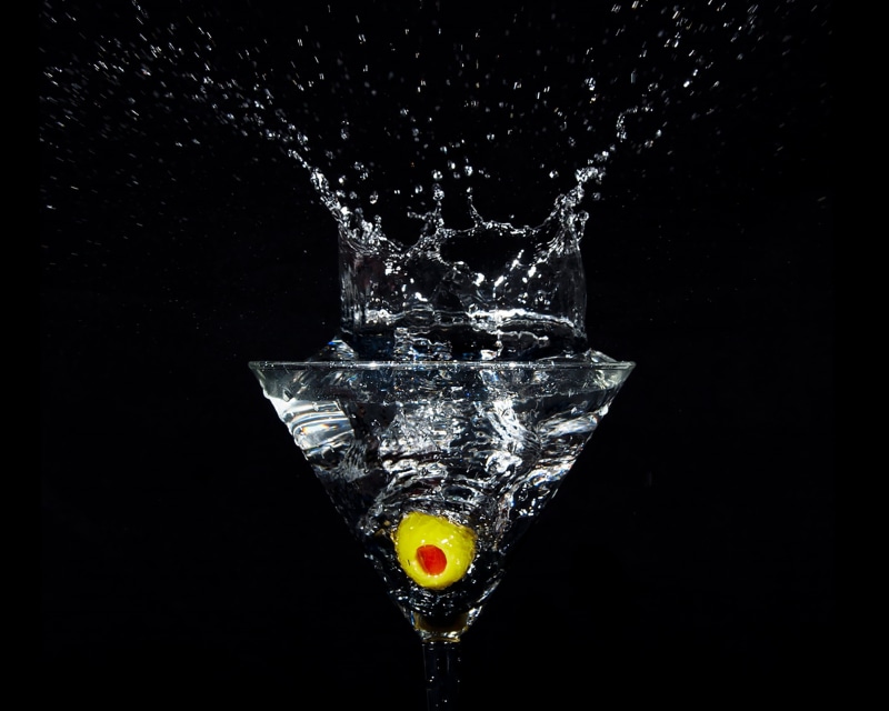 close-up, martini, splash, gin, household equipment, nature, purity, black background, motion, cocktail, celebration, food and drink, freshness, martini glass