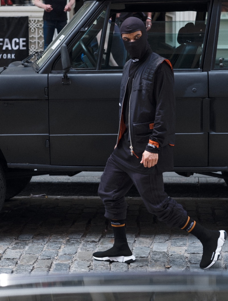 men, balaclava, public transportation, real people, standing, one person, street wear, full length, nyc, clothing, lasaye homme, lifestyles, sneakers, day
