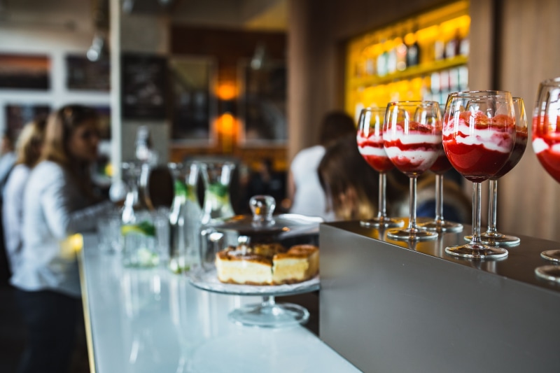 martini, household equipment, cocktail, bartender, bar - drink establishment, table, glass - material, bottle, wine, food, red wine, restaurant, bar counter
