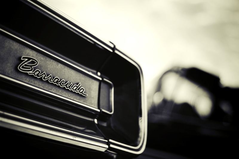 luxury, mode of transportation, global communications, emblem, selective focus, sign, macro, land vehicle, indoors, Plymouth, Muscle car, focus on foreground