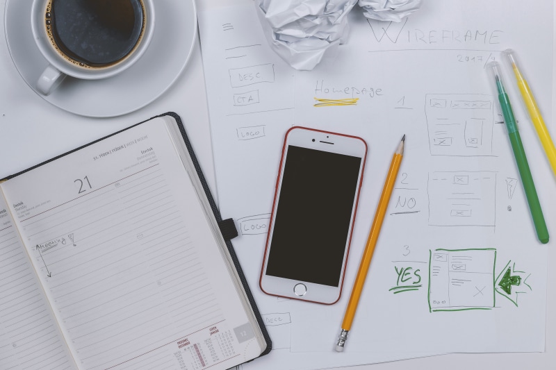 communication, coffee - drink, prototyping, coffee, diary, business, smart phone, coffee cup, indoors, blueprint, drink, technology, pen, smartphone, wireless technology
