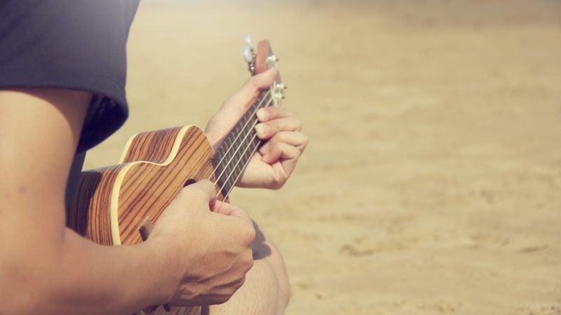 ukulele, musical instrument string, holding, enjoyment, relaxation, sand, 5K, daylight, beach, guitar, music, string instrument, musical equipment, man