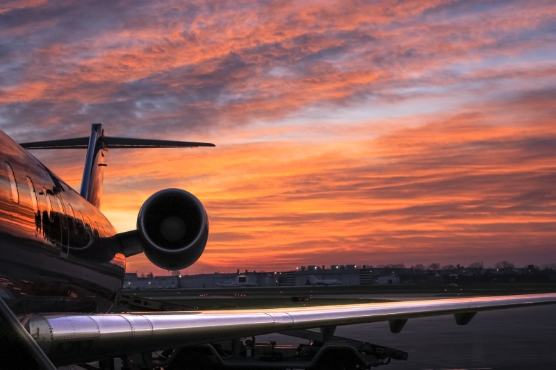 dramatic sky, built structure, building exterior, airport runway, no people, airplane, travel, wing, trip, sky, plane, sunset, aviation, speed, airliner