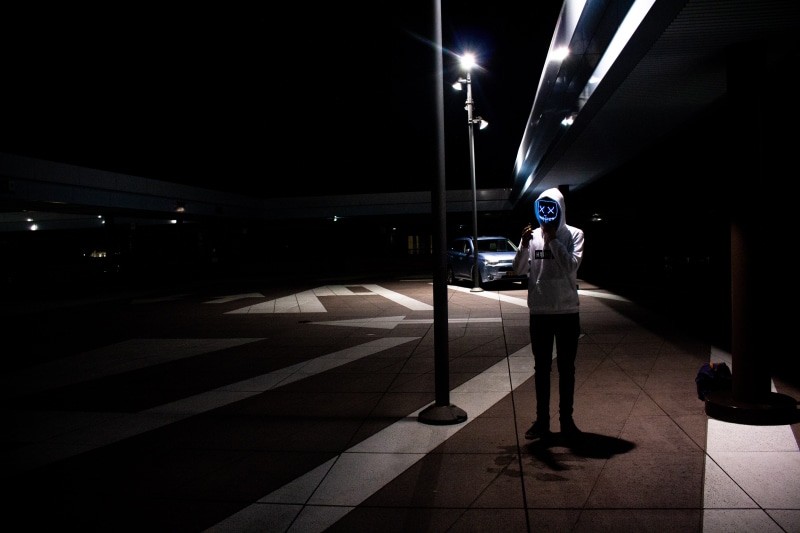 5K, led lights, casual clothing, guy, architecture, shadow, illuminated, lighting equipment, street, darkness, lights, wearing, one person, footpath, colors