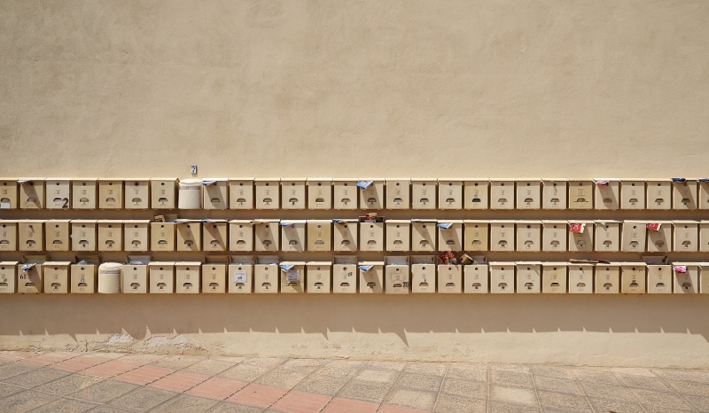 wooden box, wall - building feature, brown, piled, communication, large group of objects, control, in a row, post, tenement house, letter, indoors, arrangement
