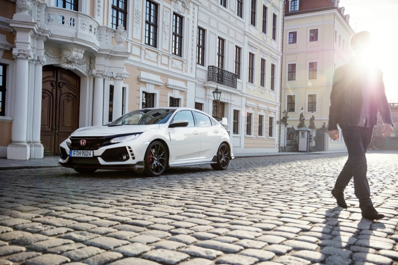 honda civic type r, adult, lifestyles, women, real people, one person, architecture, street, sunlight, cobblestone, city, racing, mode of transportation
