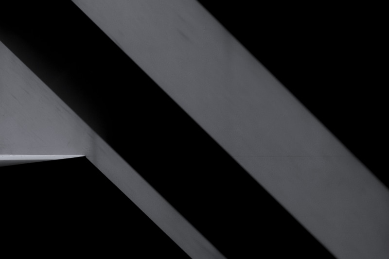 black-and-white, striped, shape, natural light, no people, minimalistic, daylight, light, minimalism, concrete, indoors, artistic, wall, perspective, full frame