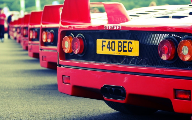 close-up, mode of transportation, sports, outdoors, car, transportation, city, old car, Ferrari F40, public transportation, sign, yellow, day, red, lot