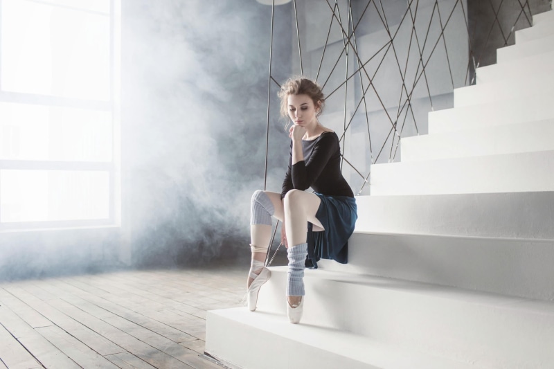 real people, sitting, indoors, lifestyles, women, 1080P, built structure, hairstyle, contemplation, legs, young adult, window, day, ballerina, young women