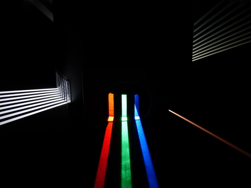 close-up, lighting equipment, mirror, redirection, multi colored, physics, studio shot, dark, light beam, indoors, light, shape, optics, sunbeam, light guide