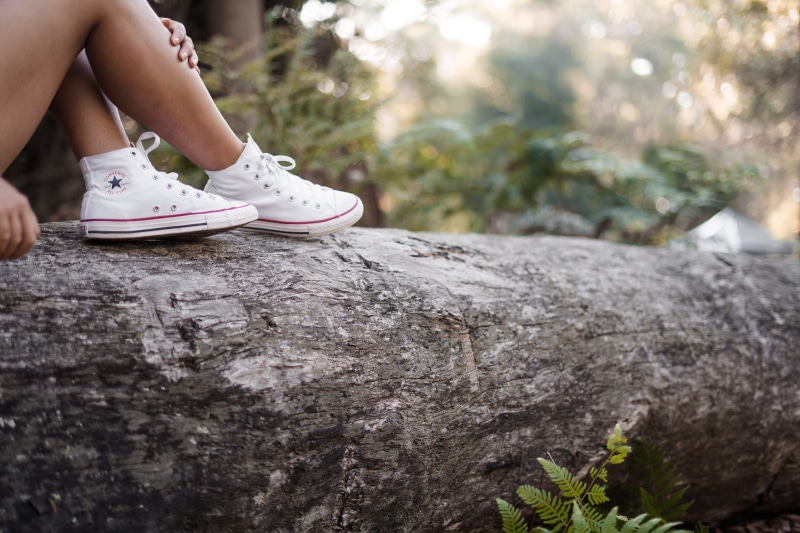 star, crouching, one person, depth, person, running shoe, rock, shoe, white, 5K, reflecting, shoes, casual clothing, plant, bush, human, logs, solid, apparel