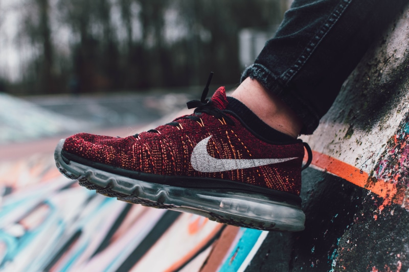 depth of field, 5K, low section, shoe, fashion, close, style, wear, relaxation, red, men, person, human limb, focus on foreground, human foot, design