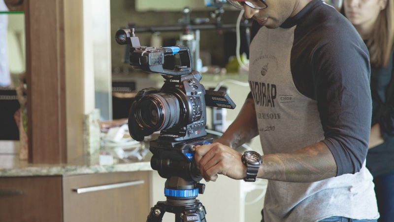 holding, occupation, film, adult, man, effort, photography, working, industry, one person, focus on foreground, photographer, lens, filming, skill, men