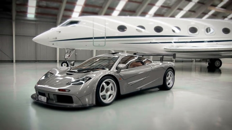 bmw, car, shiny, indoors, parking lot, racecar, metal, McLaren F1, mode of transportation, silver colored, no people, vehicle, land vehicle, sports car