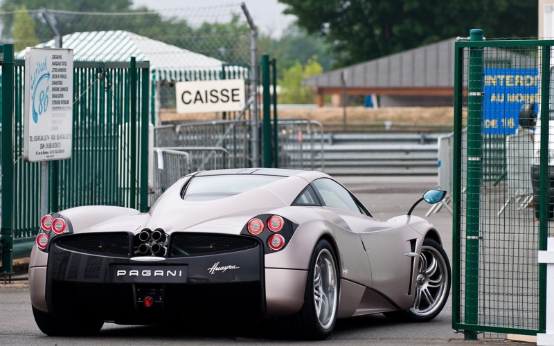 communication, luxury, racecar, motor vehicle, land vehicle, pagani, day, number, motor racing track, focus on foreground, text, no people, transportation