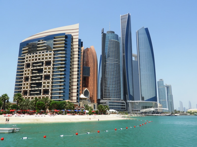 office building exterior, etihad towers, clear sky, outdoors, architecture, sky, water, urban skyline, financial district, travel, united arab emirates