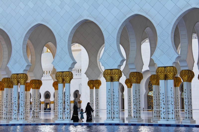 gold, people, dome, place of worship, tourism, built structure, water, travel, arch, building exterior, women, famous, landmark, architectural column, sheikh zayed grand mosque