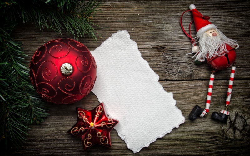 high angle view, red, doll, paper, snow, tree, wooden surface, 2K, Christmas, ornament, holiday, ribbon, wood - material, leaves, holiday - event, claus