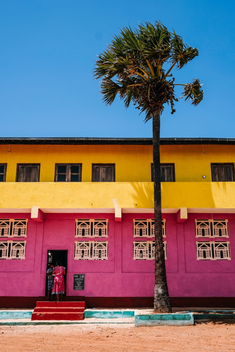clear sky, doorway, entering, day, nature, clear, residential district, pink color, built structure, near, outdoors, pink, entrance, coconut, colour, concrete