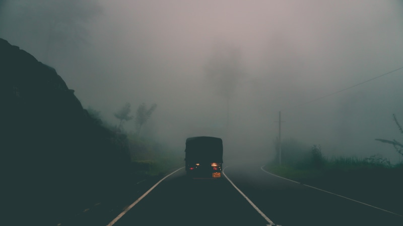 car, gravel, mountain, foggy, black, travel, sign, direction, landscape, scenery, sky, vehicle, haze, road, transportation, highway, motor vehicle, land vehicle