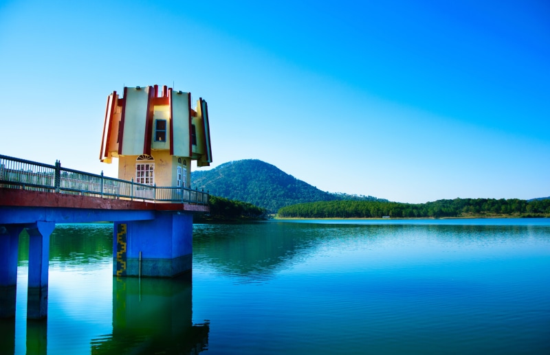 outdoors, reflection, blue, building exterior, beauty in nature, sky, tranquil scene, built structure, lake, tranquility, natural, landscape, architecture