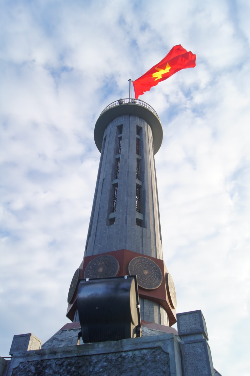 tower, flag, viet nam, patriotism, red, building exterior, vietnam, low angle view, history, day, tall - high, ha giang, nature, no people, sky, built structure