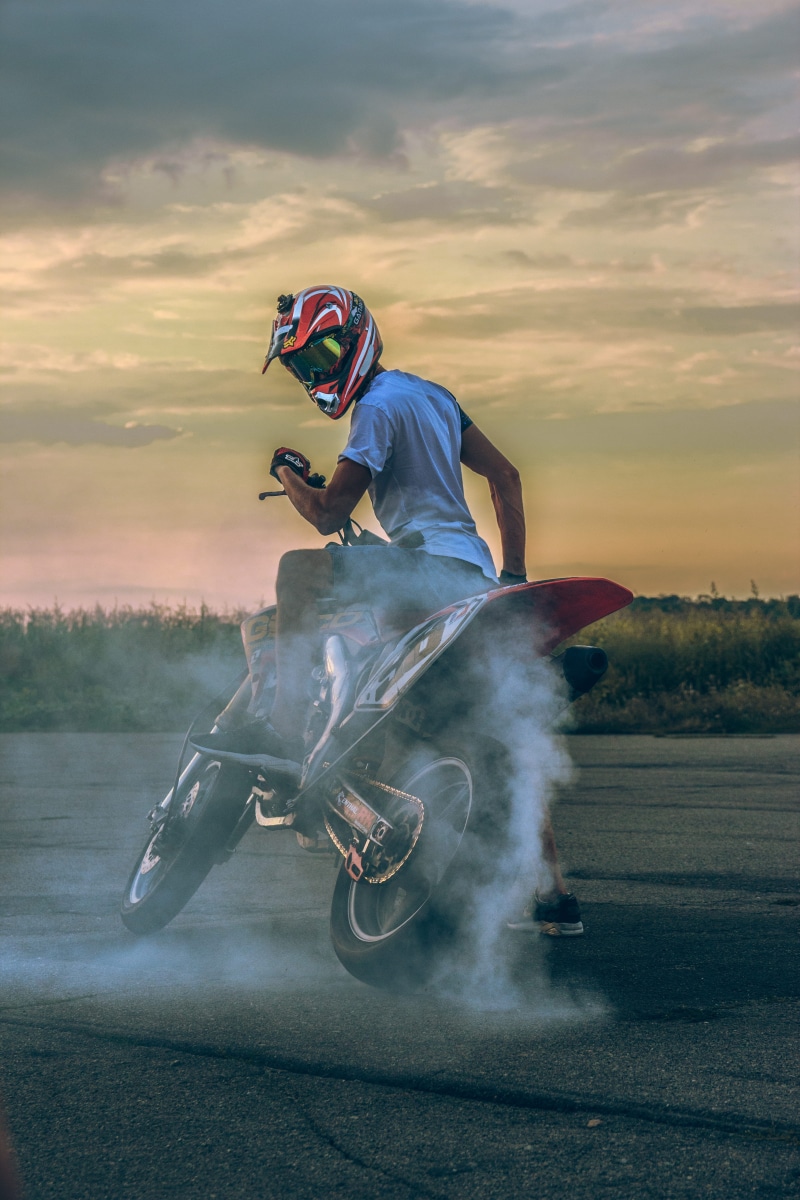seated, full length, speed, real people, action, photo, motion, moto racing, smoke, helmet, motocross, headwear, competition, vehicle, sky, sports helmet