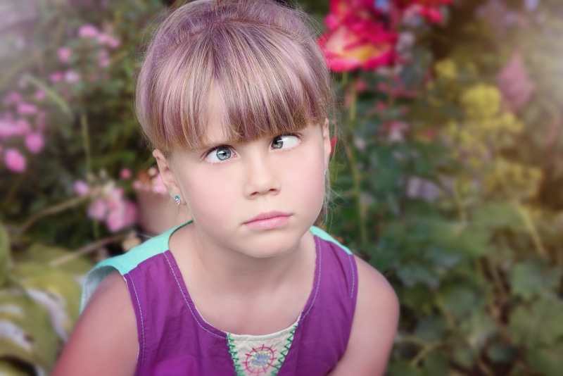 human, children only, purple, headshot, contemplation, day, casual clothing, real people, front view, hairstyle, innocence, flowers, face, child, one girl only