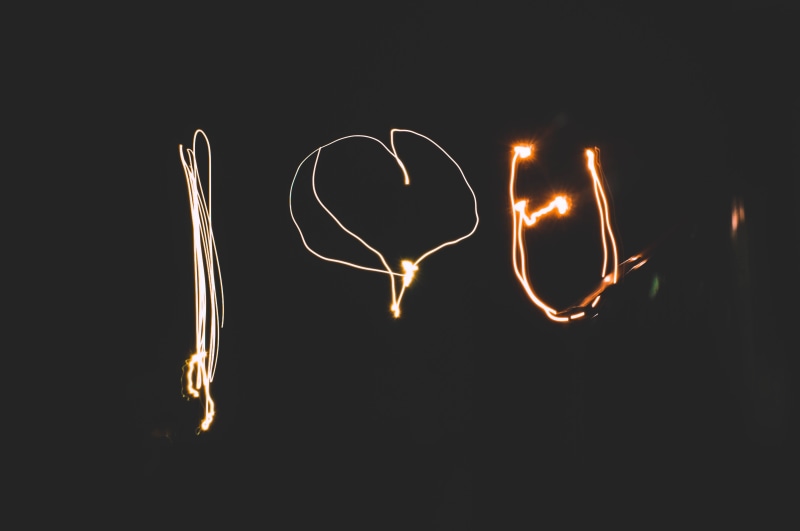 word, indoors, flashlight, 4K, movement, black background, night, paint, close-up, emotion, cute, artificial, words, light, heart shape, burning, love