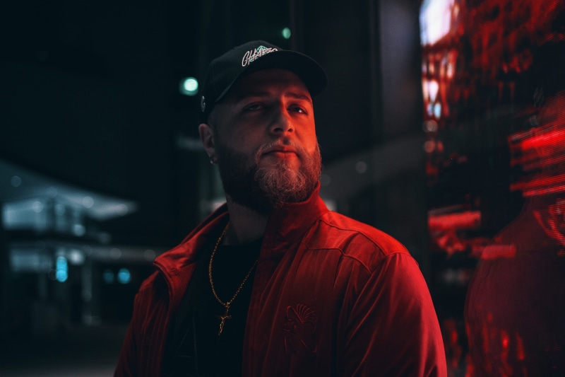 urban, portrait, necklace, night, looking, wearing, fashion, look, mid adult men, light, city, dark, cap, red, focus on foreground, occupation