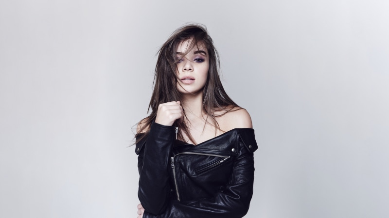brunette, one person, front view, gray background, young women, fashion, black jackets, standing, 4K, leather jackets, hair in face, Hailee Steinfeld