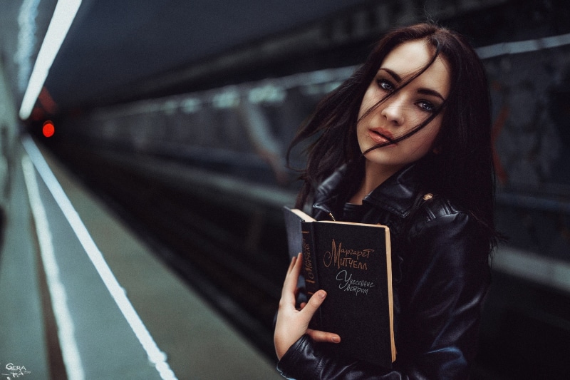 model, mode of transportation, blue eyes, casual clothing, women, beautiful people, 1080P, teenager, holding, black hair, hair, looking at viewer, books