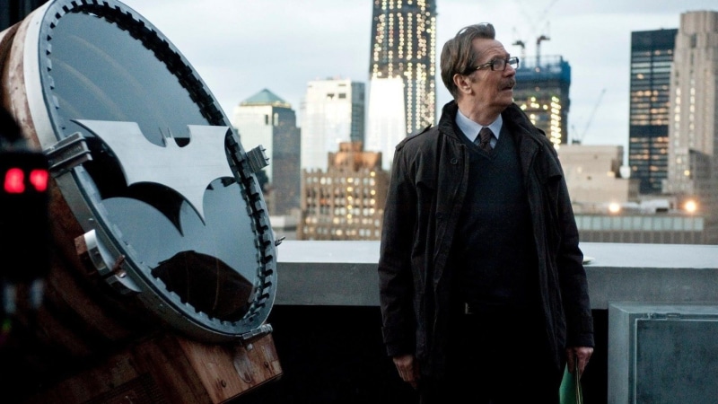 Gary Oldman, adult, waist up, Batman, skyscraper, front view, black, men, Bat Light, focus on foreground, Dark Knight Trilogy, architecture, Commissioner Jim Gordon