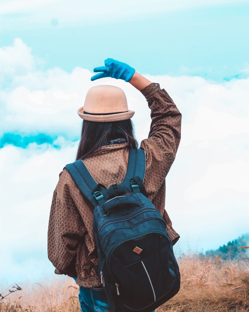 standing, environment, focus on foreground, hat, real people, nature, sky, behind, fog, winter, mountain, girl, one person, scarf, hiking, leisure activity