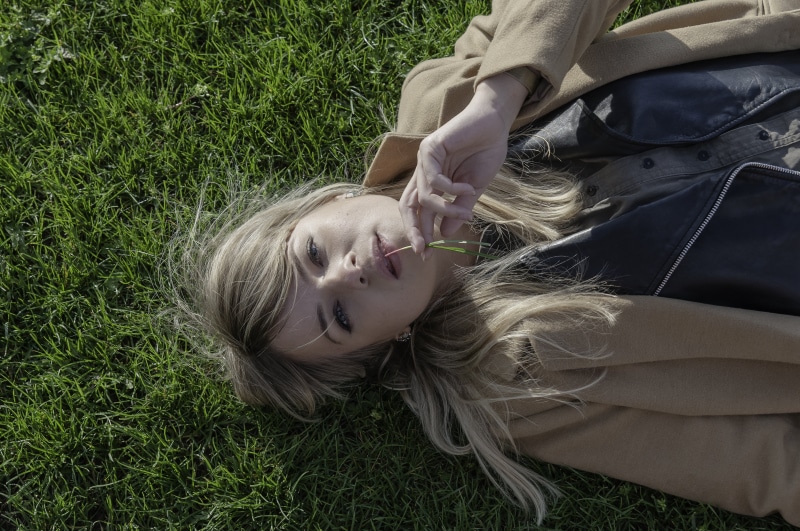 feeling, leisure activity, face, caucasian Ethnicity, expression, lying, people, cheerful, grass, beautiful woman, hair, happiness, young Adult, emotion