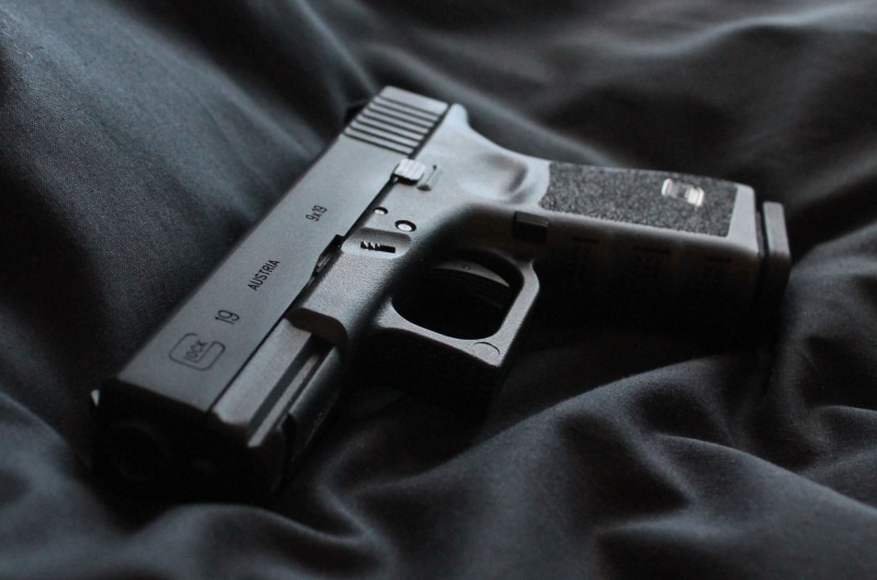 2K, black color, automatic, high angle view, weapon, no people, crime, aggression, jeans, communication, glock 19, textile, close-up, social issues, indoors