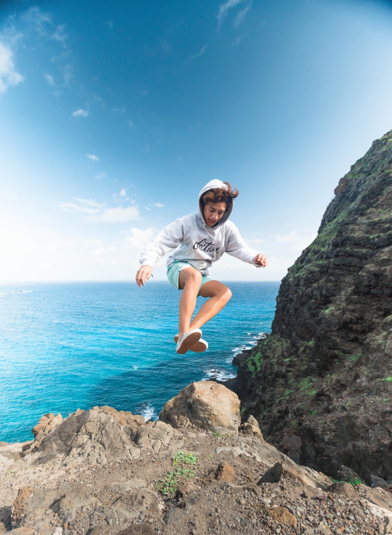 cliff coast, outdoors, 5K, hoodie, casual clothing, wearing, hoody sweater, real people, solid, man, rock - object, sea, one person, ocean, lifestyles
