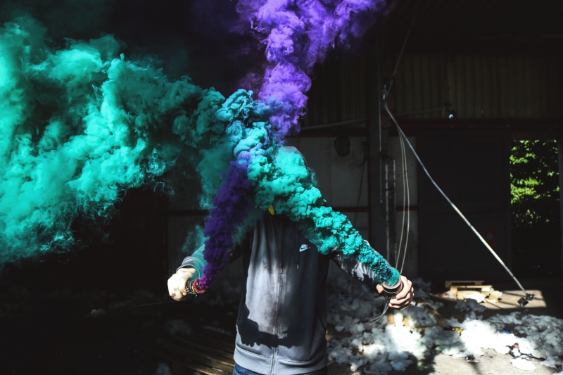 person, smoke, bottle, one person, built structure, leisure activity, front view, smoke grenade, smoke - physical structure, nature, building exterior