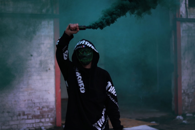 wall - building feature, front view, real people, 5K, obscured face, smoke grenade, waist up, clothing, men, signalling, standing, lifestyles, leisure activity