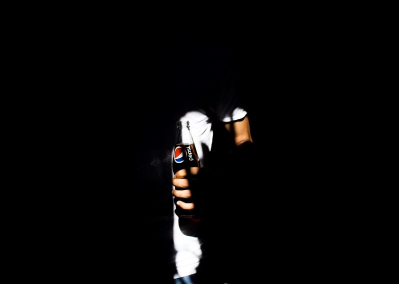 bottle, untitled, 1080P, one person, unrecognizable person, light, human hand, human face, fizzy, lifestyles, indoors, finger, shade, dark, product, cola