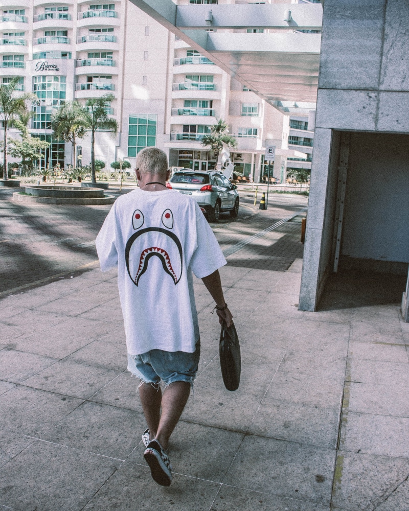 bape, day, built structure, urban area, photo, man, child, real people, bag, standing, t, childhood, one person, city, street, boys, buildings, streetwear