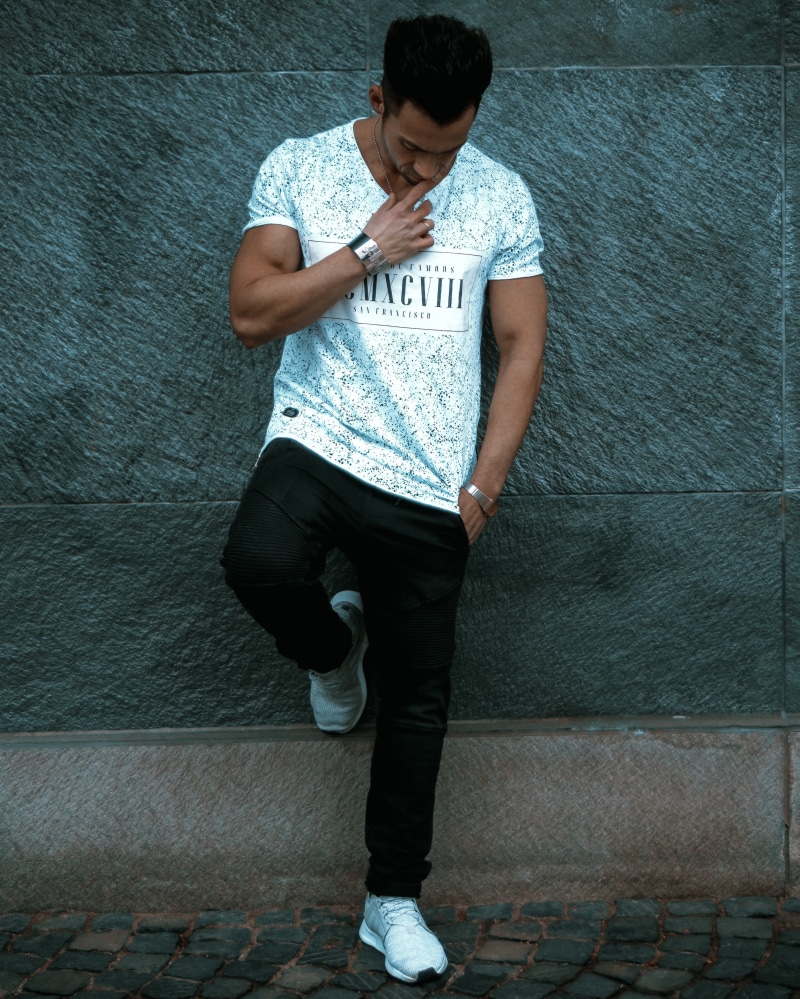 muscular, casual clothing, leisure activity, young, standing, man, one person, wear, adult, portrait, wearing, wall, architecture, black pants, wall - building feature