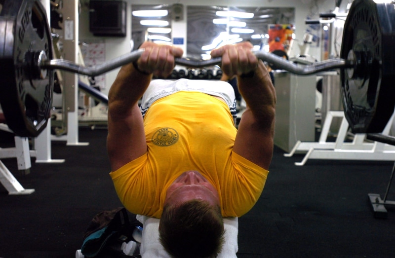 power, 1080P, male, indoors, adult, muscular, neck, shirt, bodybuilding, strength, t, lifestyles, barbel, yellow, rear view, effort, one person, crew-neck