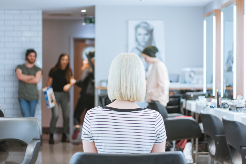 focus on foreground, hairstylist, young men, office, males, women, indoors, blonde, young adult, casual clothing, fashion, salon, hair cut, headmaster